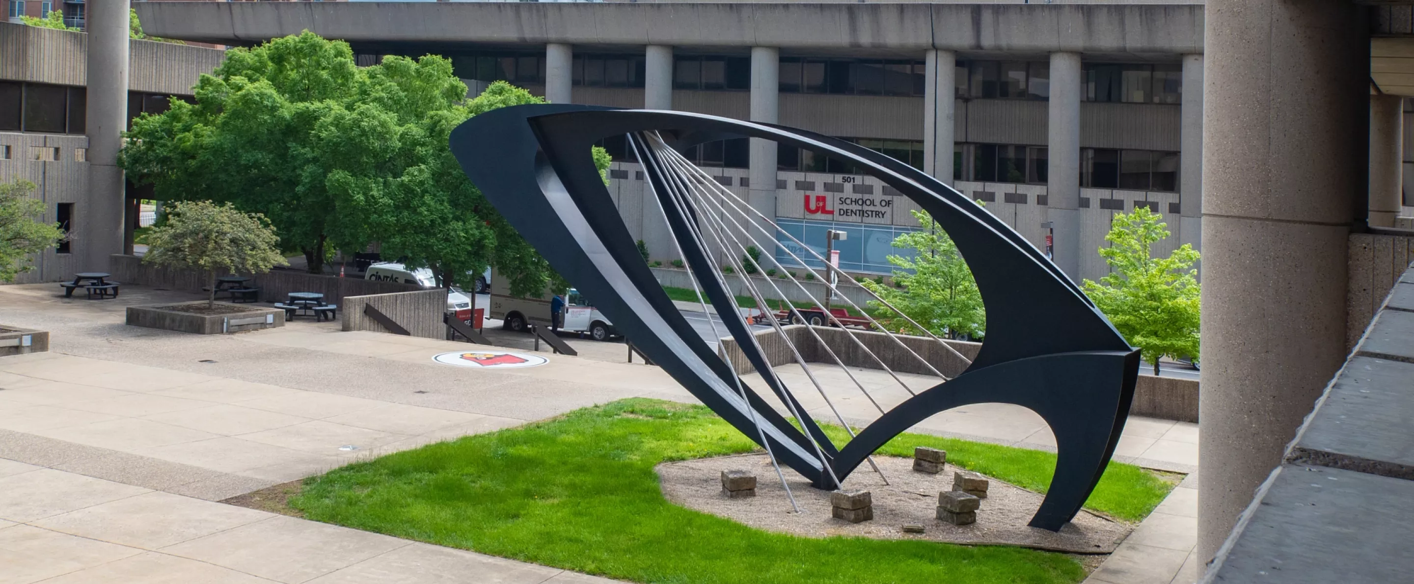 View of the School of Dentistry from Kornhauser Library, with the Ad Astra Sculpture in the foreground
