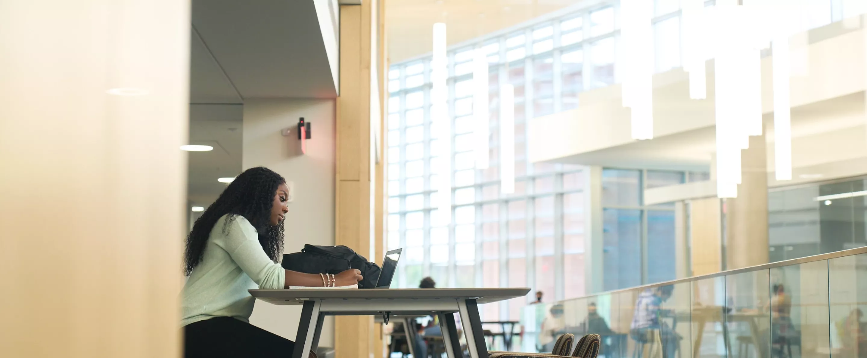 Student studying at a table in the BAB.