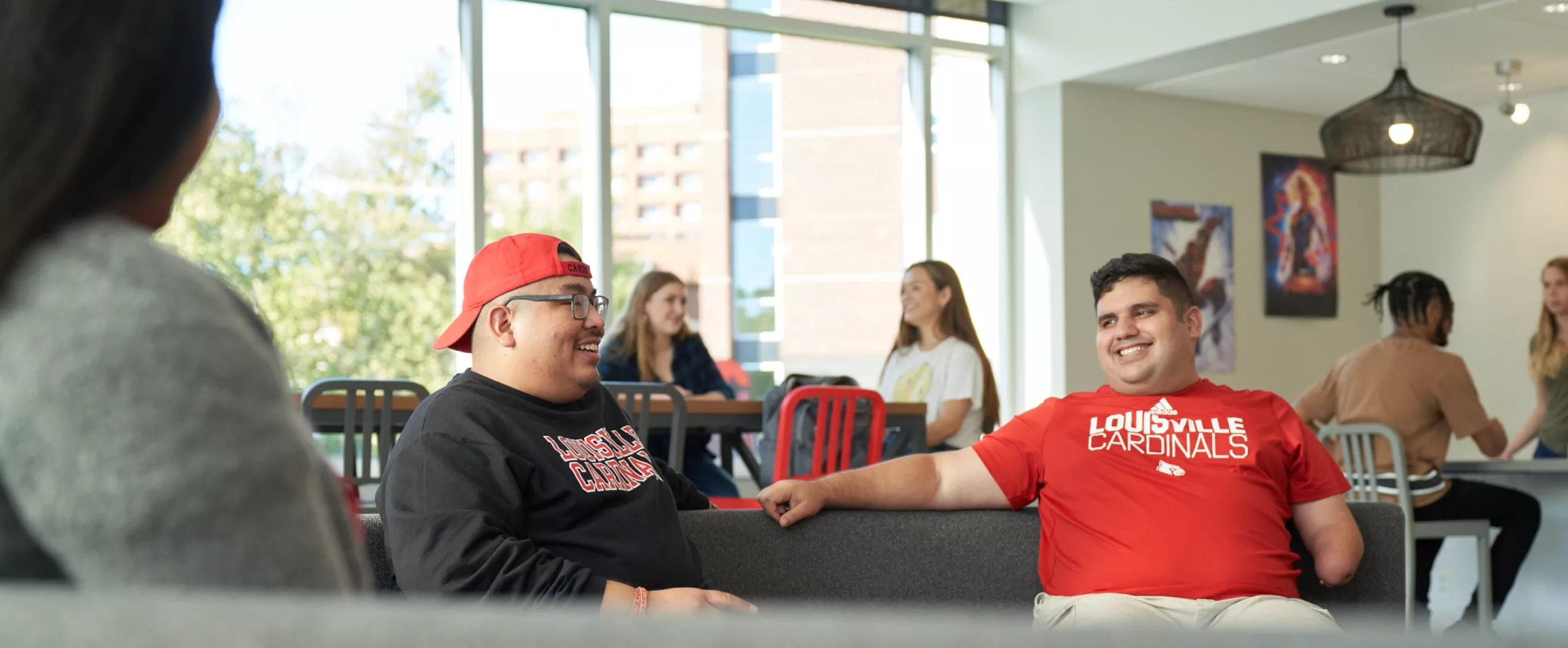 Students sitting on the couches and talking in the Belknap Residence Hall.