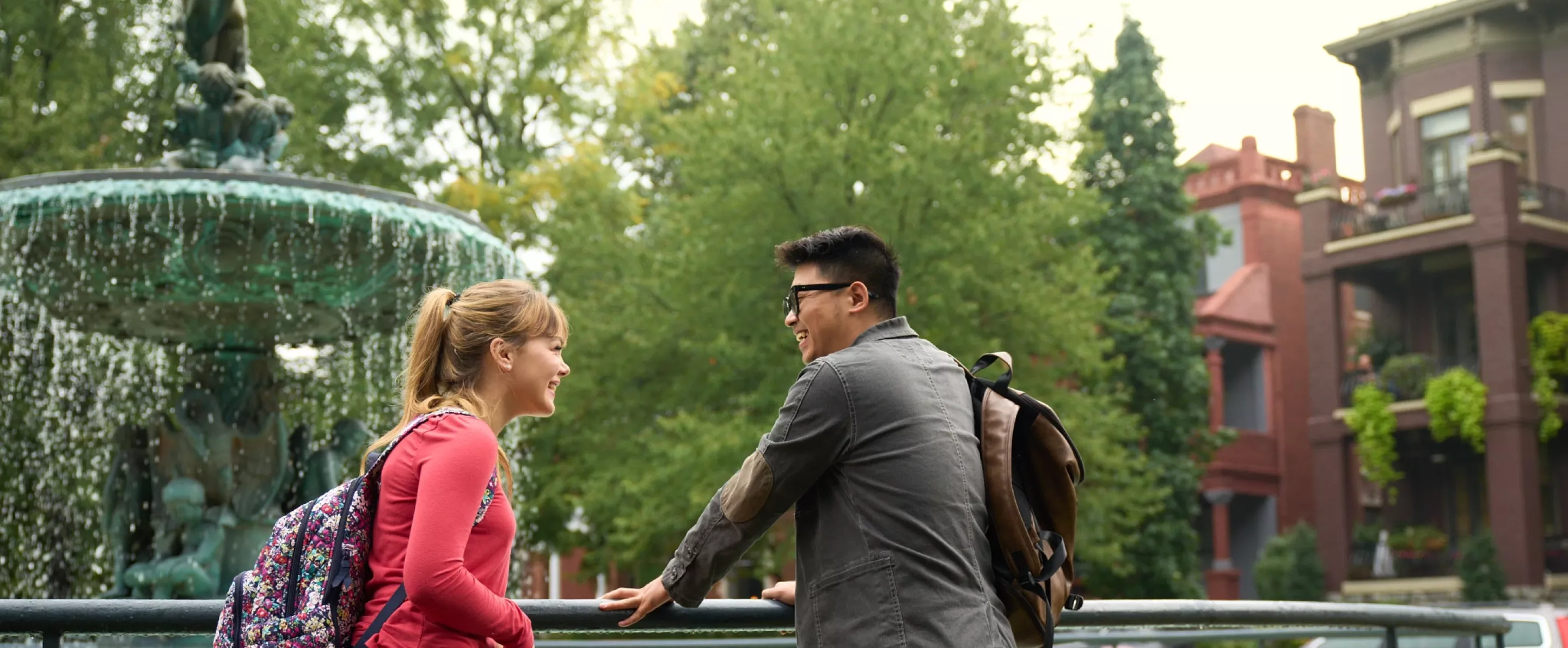 Two students talking beside the fountain in Old Louisville's St. James Court.