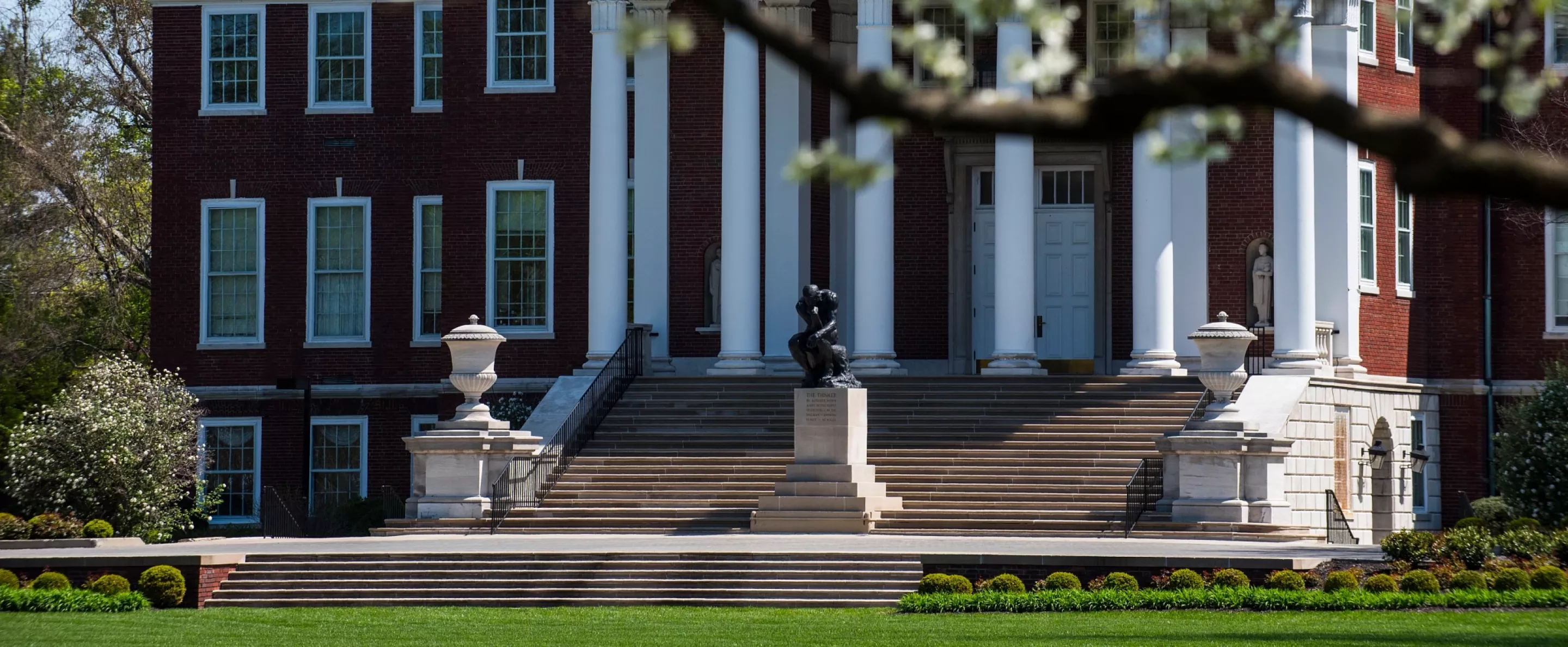 Exterior of Grawemeyer Hall with spring trees in bloom