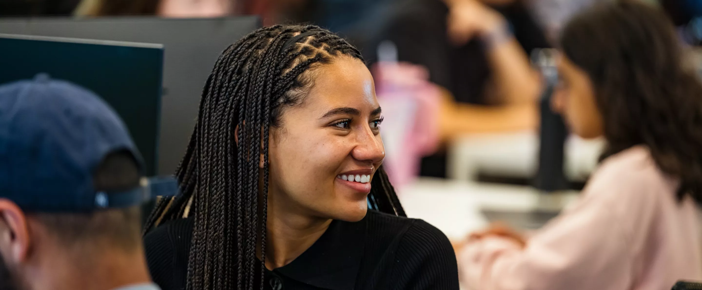 Student smiling in a lecture in the School of Medicine