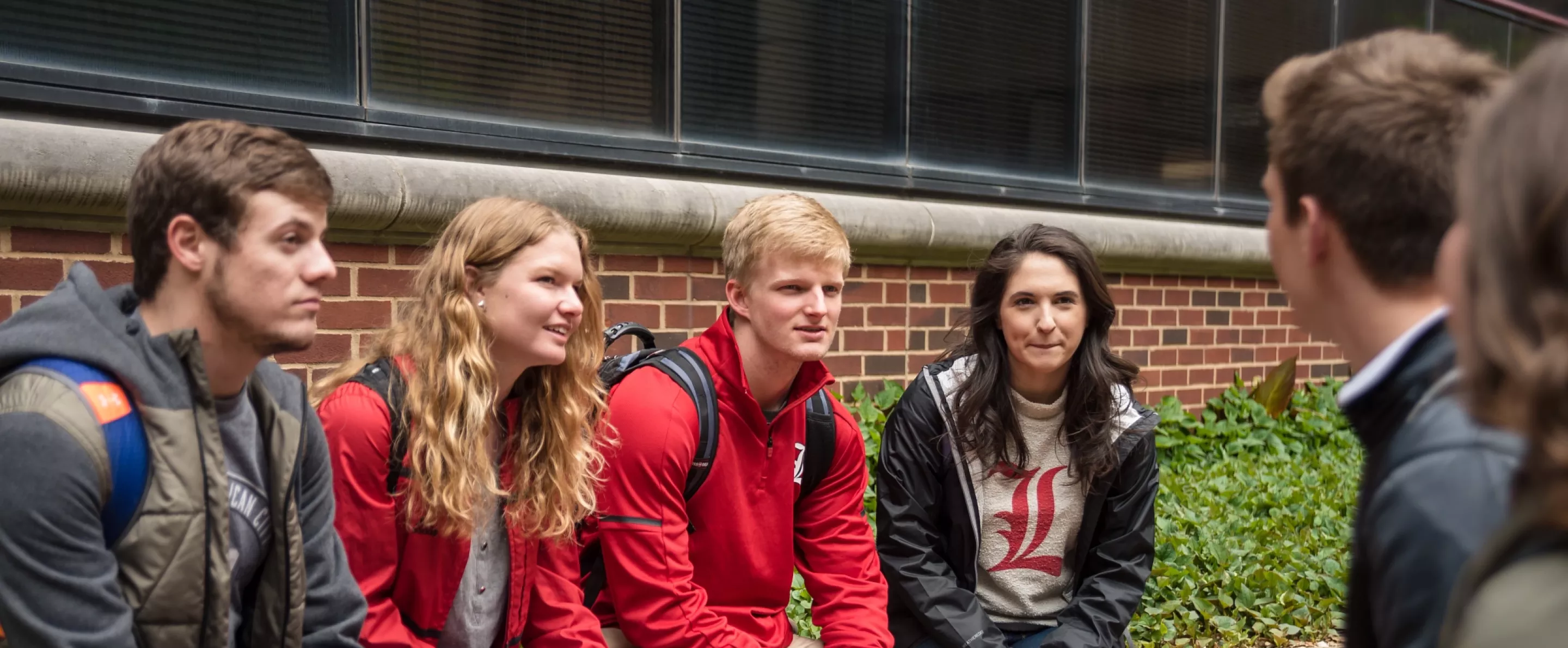 Students sit outside the College of Business