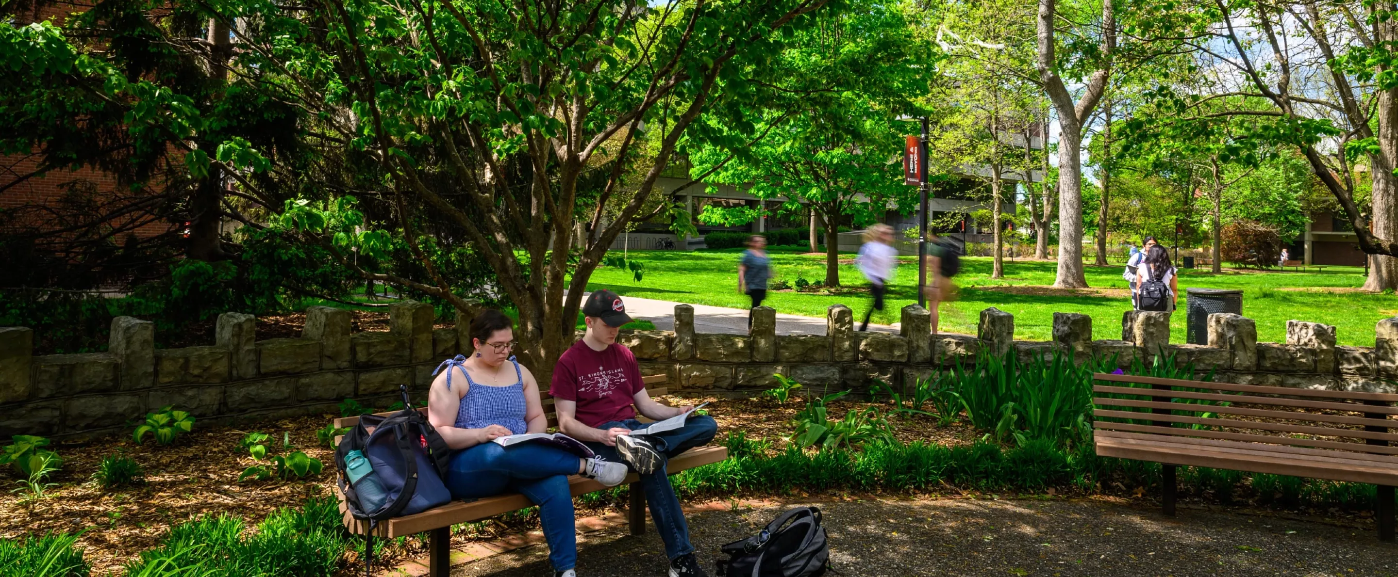 Students sittin on a bench in Parrish Court