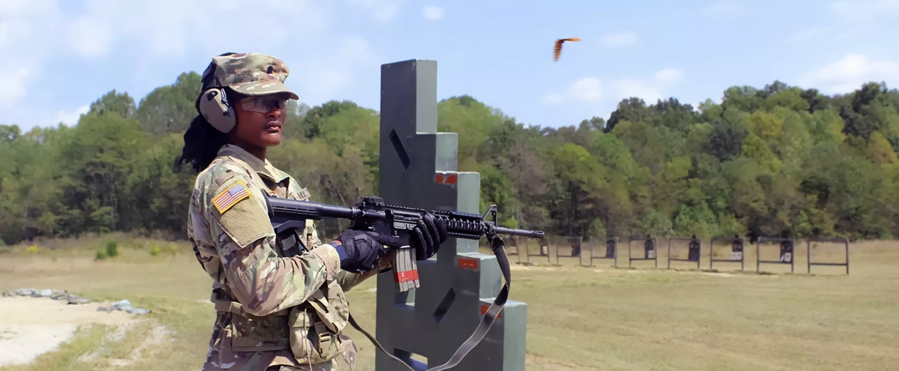 ROTC Cadet standing with a firearm