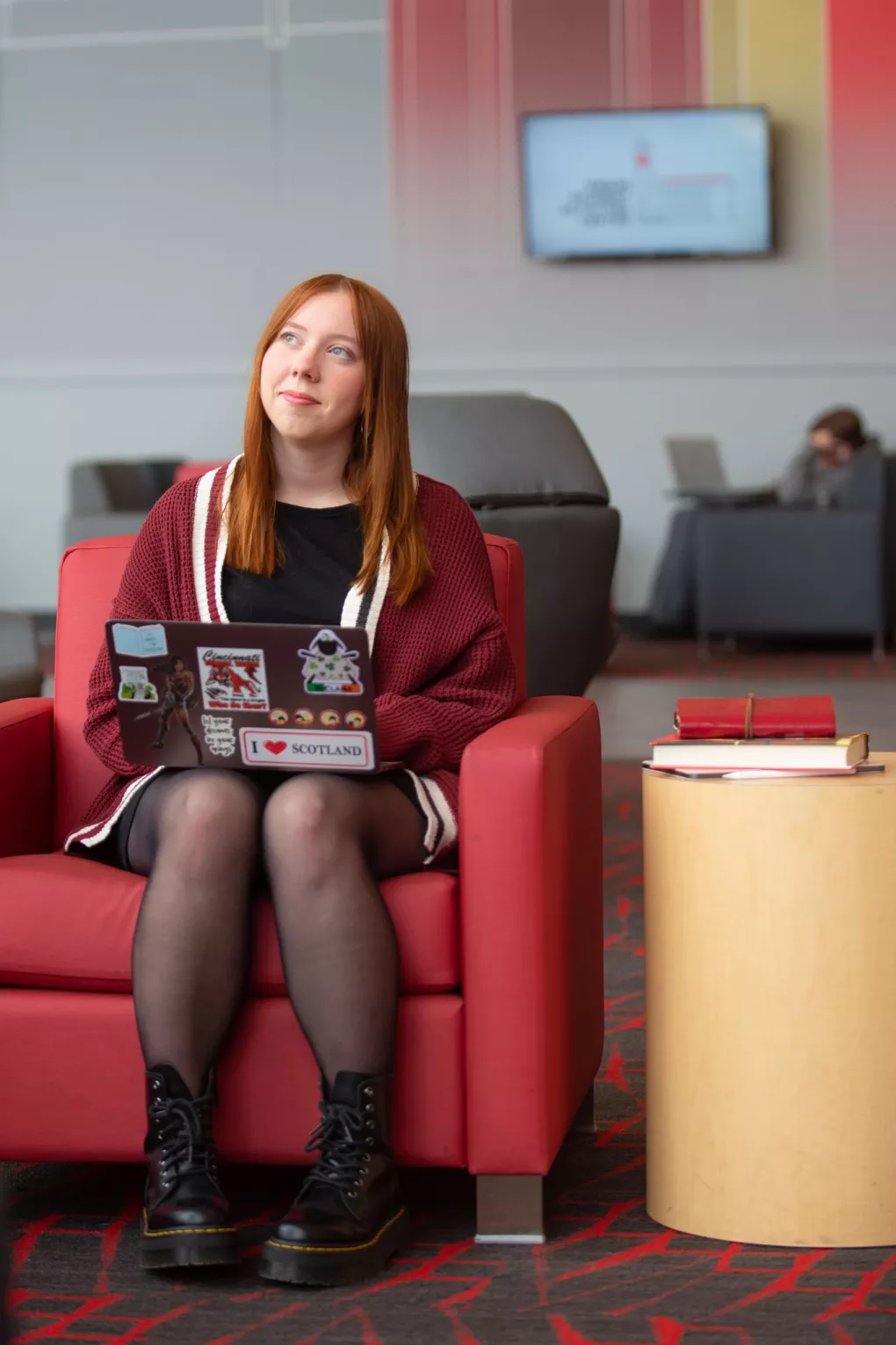 A student pauses in thought while working on a laptop in the Belknap Academic Building