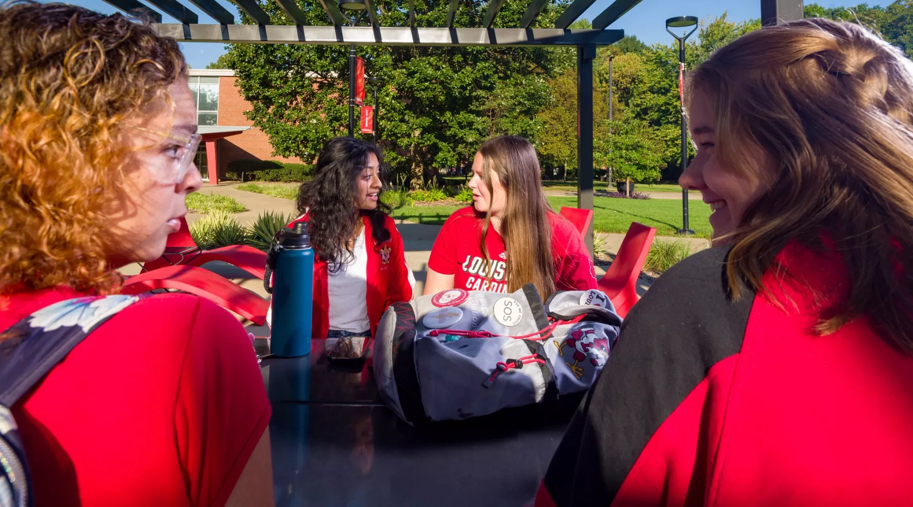 Four students at a table talking and studying