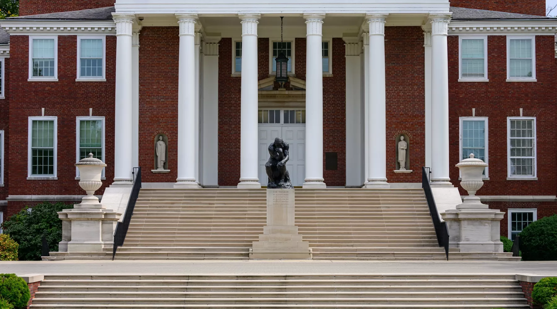 Front view of The Thinker statue and Grawemeyer Hall steps