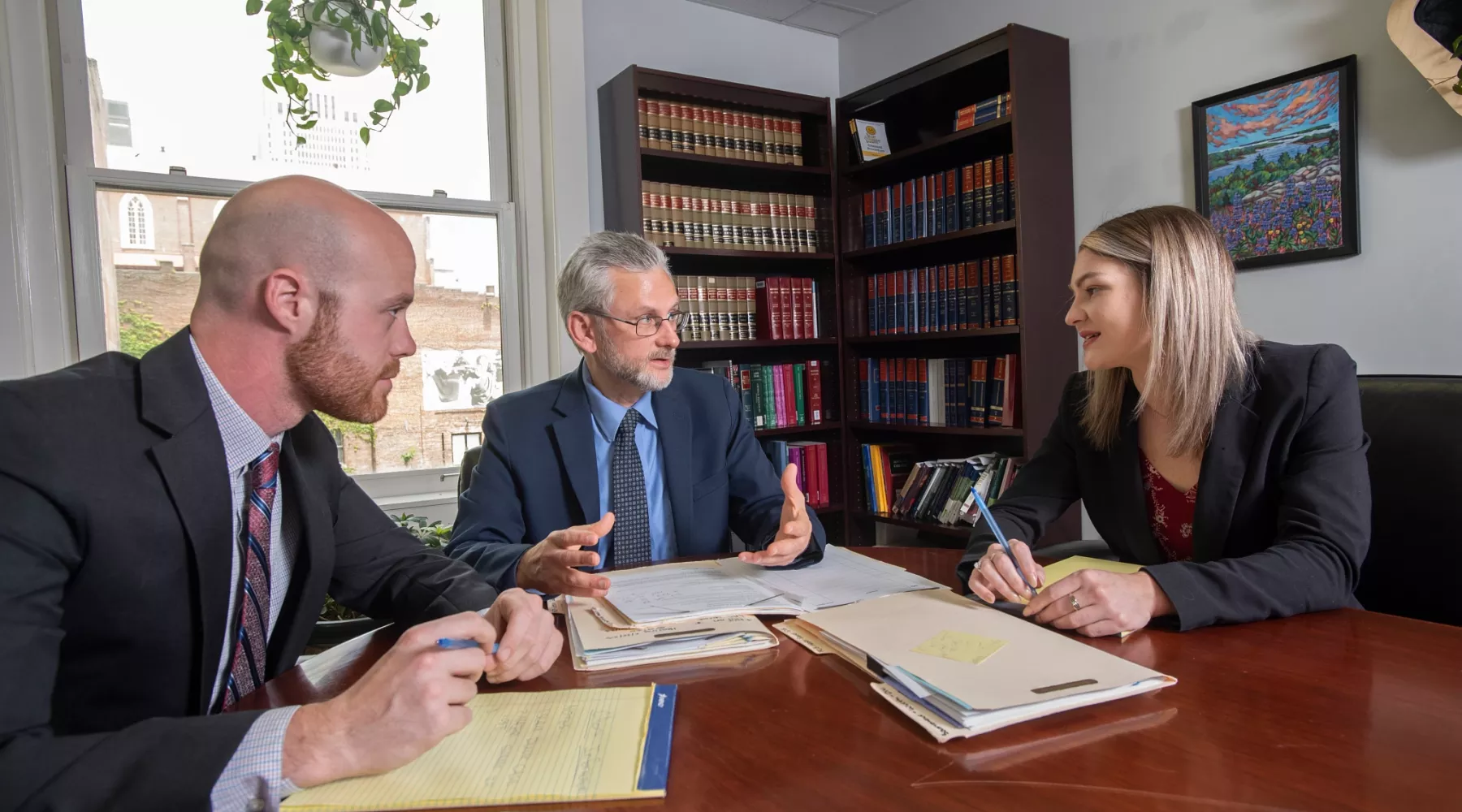 Alumni and students discuss a case at the Ackerson Law Clinic