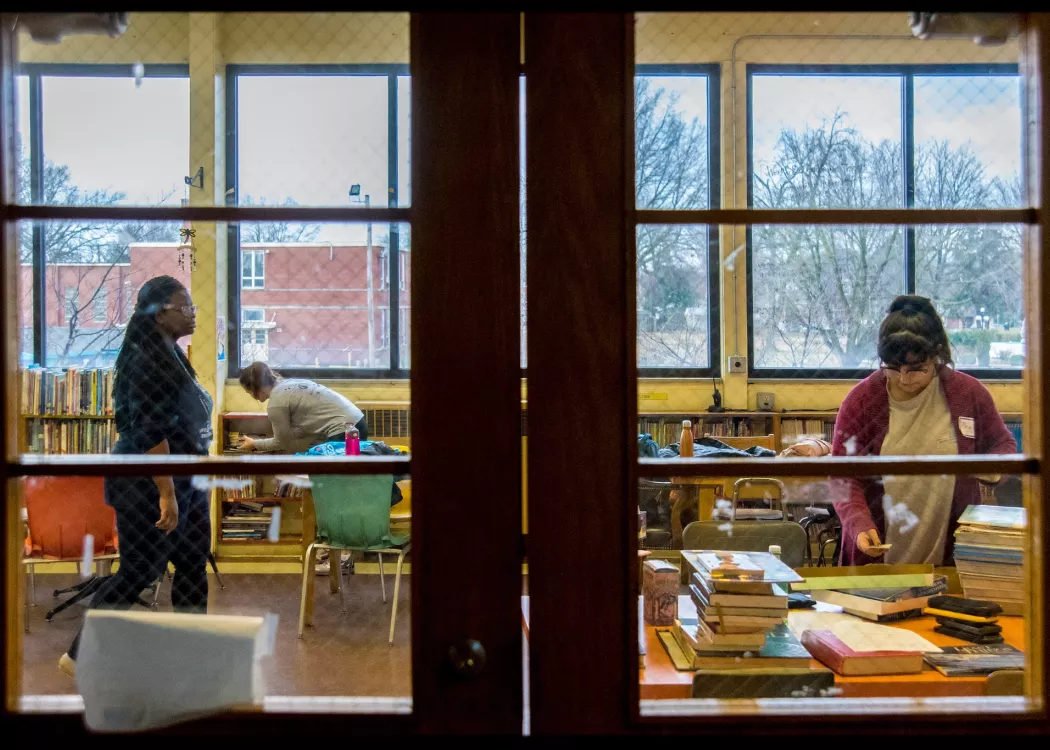 Students in a classroom shot from behind closed doors looking in