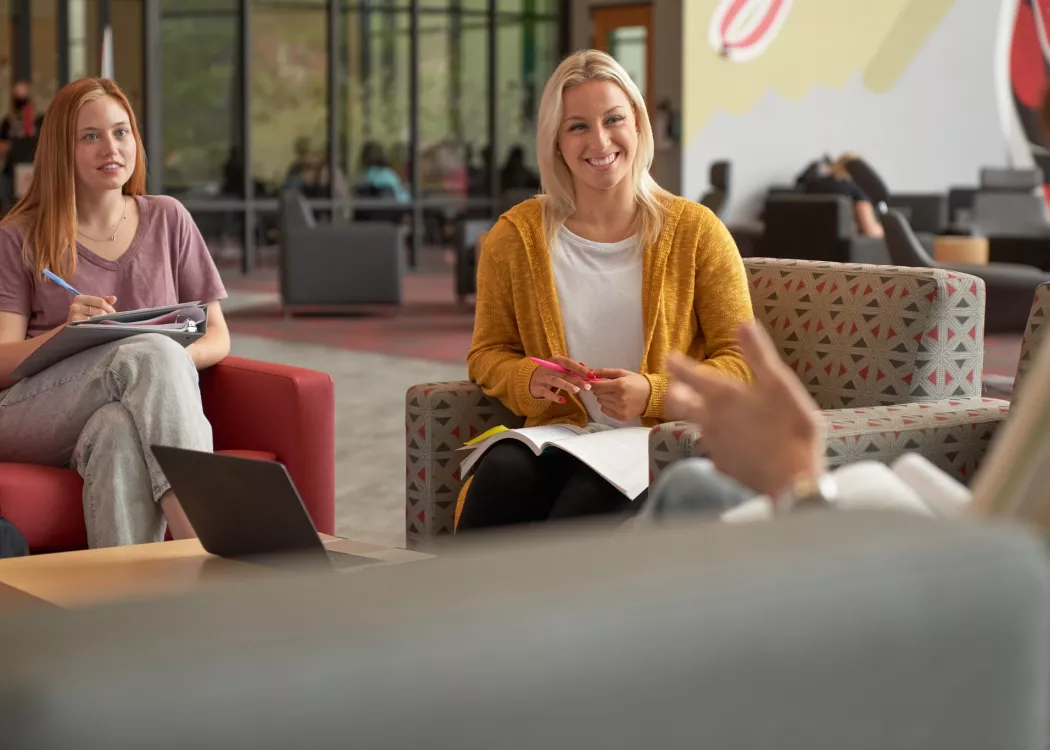 Students sitting around and talking in the SAC.