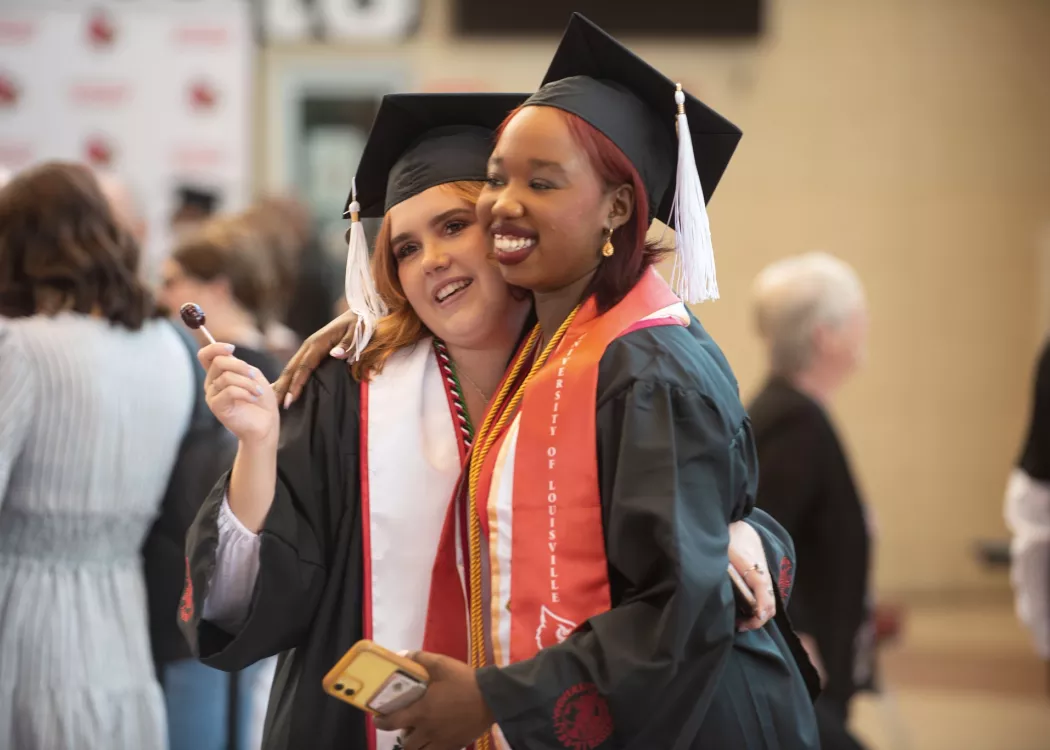 Students hug in celebration at Commencement 2022