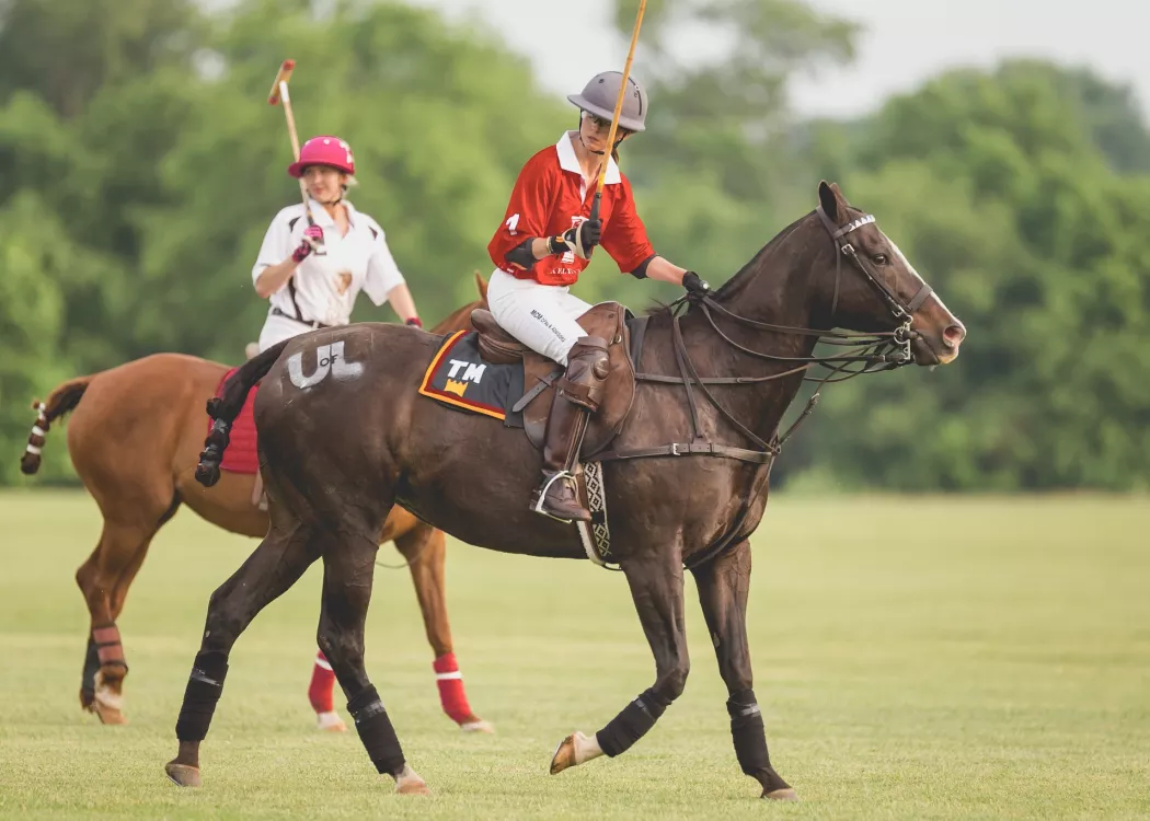 Two women playing polo