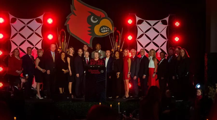 President Schatzel on stage with honorees at the 2023 Alumni Awards