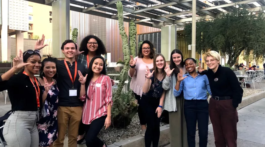 ACC Leadership Symposium group posing outside making the L symbol with their hands