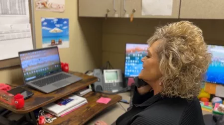 receptionist working on laptop
